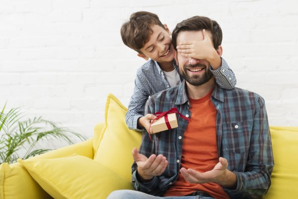 lovely-son-making-surprise-his-father